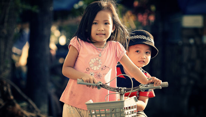 siblings on bike