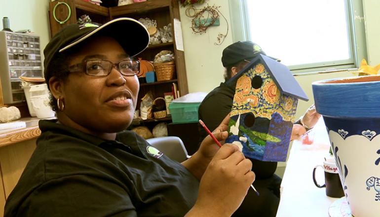 ETC crafts, a woman painting birdhouse