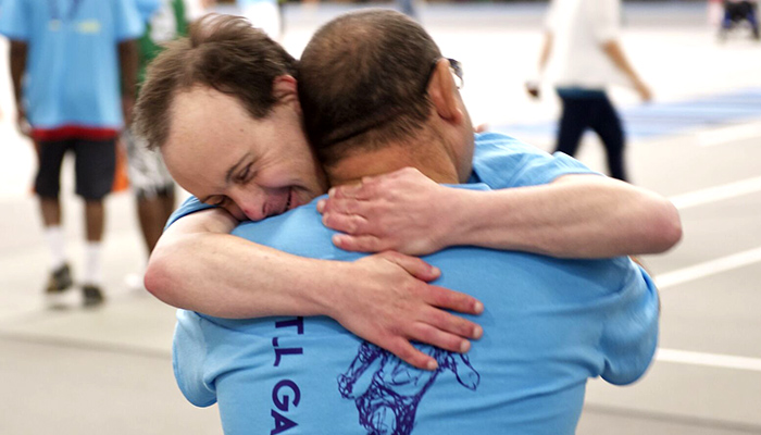 Athlete hugging a teammate