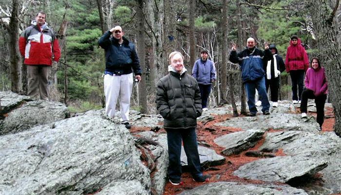 Outing Residential Group hike standing on rocks 700