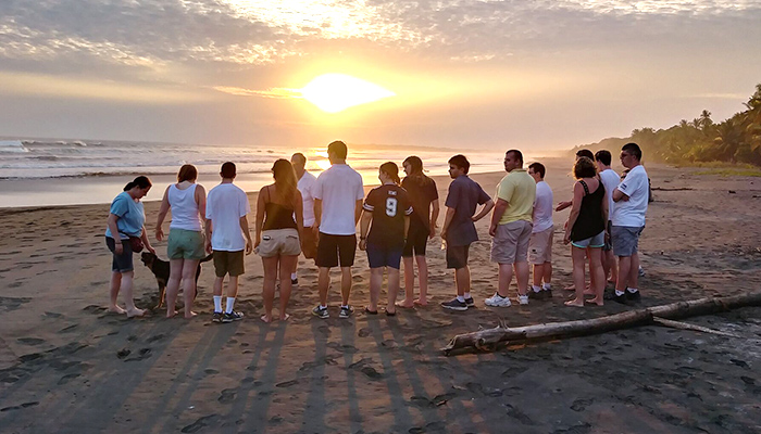 Group photo of supported trip beach