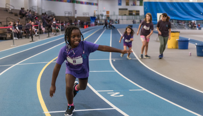 Child running at track event