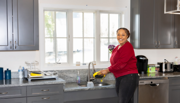 Woman at sink in modern and accessible kitchen