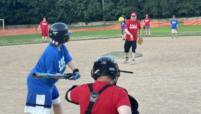 Individuals playing baseball