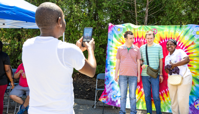 A guy taking photo of a group of 3