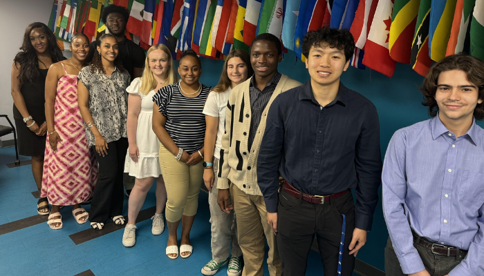 Intern Group photo in front of flags