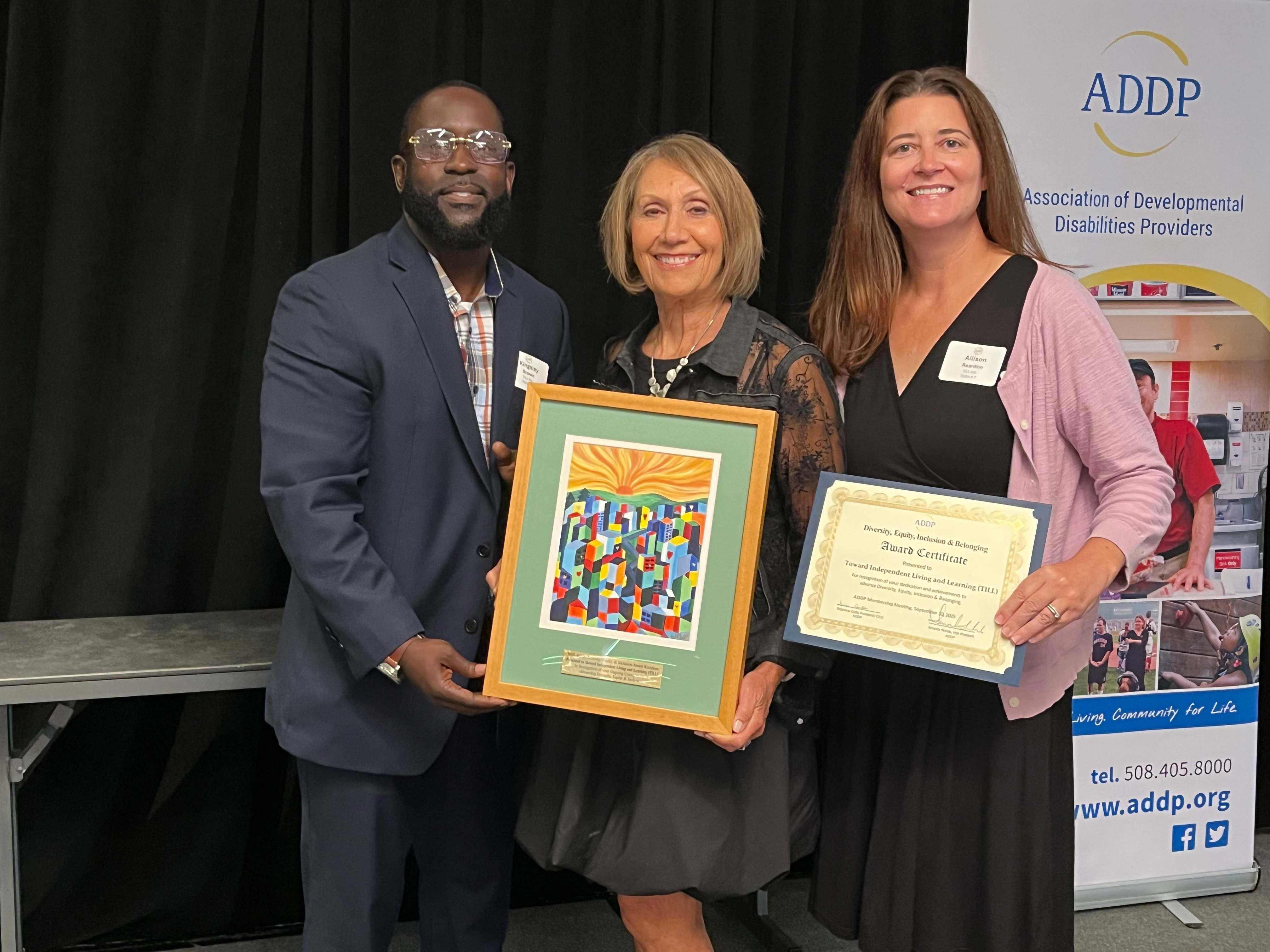 Dafna, Kingsley, and Allison holding up ADDP Award
