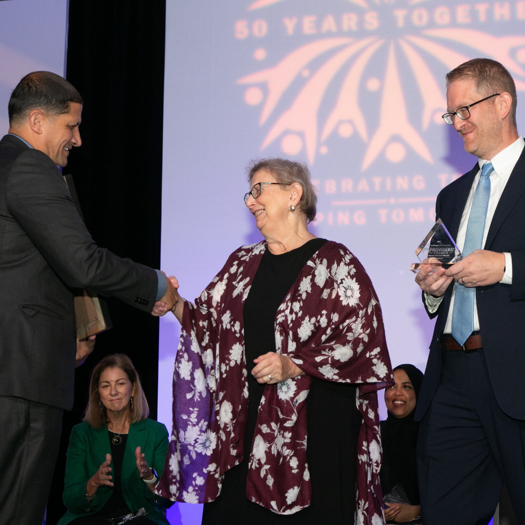ETC Gina shaking hands while receiving award for Supervisor