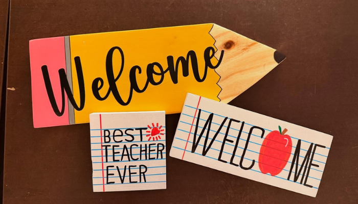 Three wooden welcome signs created by Cravings