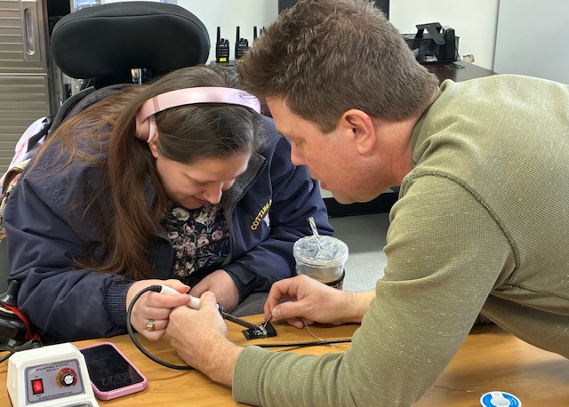 Caleb teaching a individual at TCB 