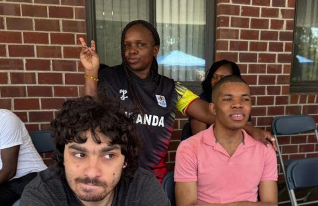 Doreen Natambi holding a peace sign with other individuals in the photo