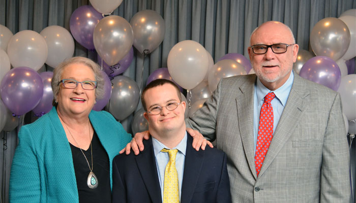 man with parents at gala