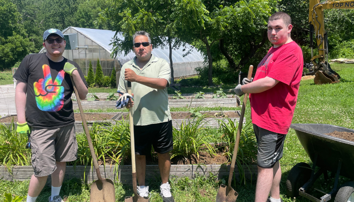 3 Individuals with shovels at TILL Farms