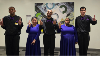 Group of young adult dancers flashing peace signs