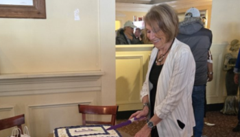 Woman cutting anniversary cake