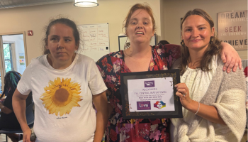 Three people with a award at Chelsea