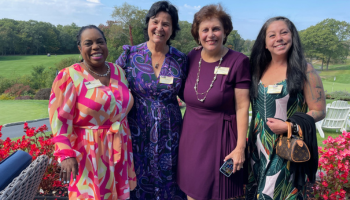 4 women together smiling on a sunny day