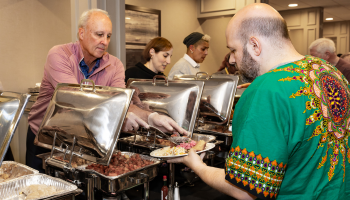 Someone filling up their plate with food