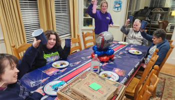 Residential home together at the table for a patriots watch party 