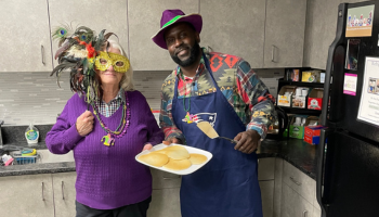 Kingsley and Paula making pancakes for dedham office for Mardi Gras