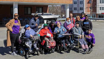 Group photo of individuals in front of Delorean