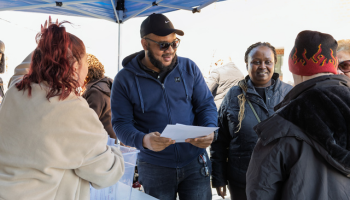 A man with other receiving a packet 