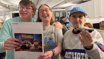 three people smiling with a April Madness packet