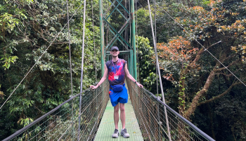 A boy in the middle of a bridge in Costa Rica