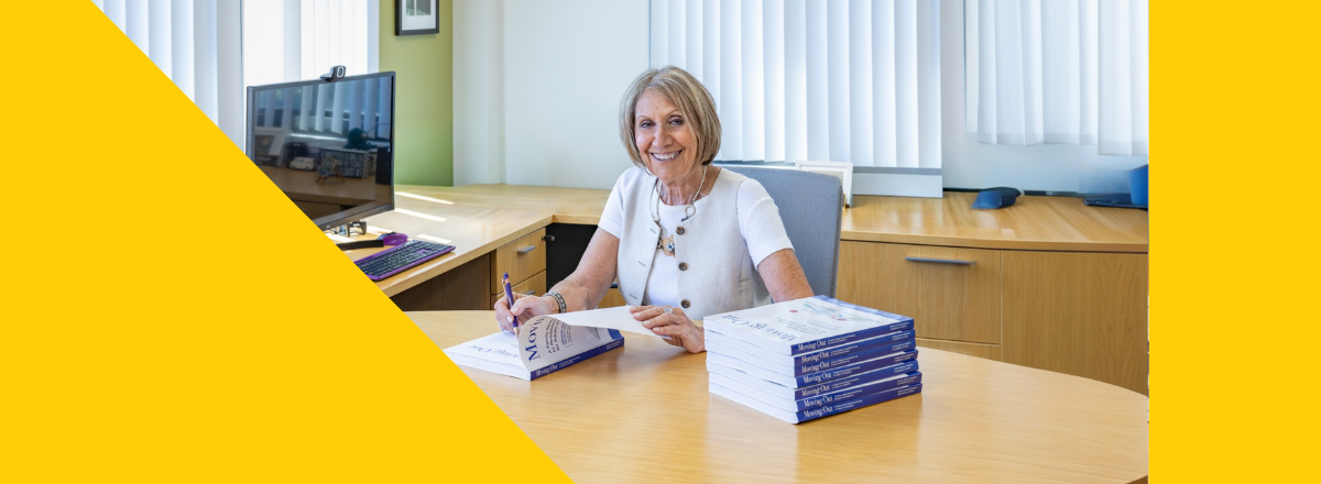 Dafna Signing with yellow banner on left and right