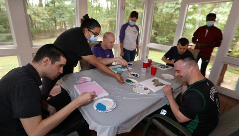 Littleton group residence creating project on screen porch with staff