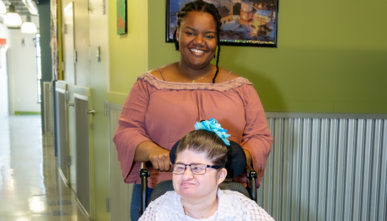 Staff and individual in wheelchair at day program