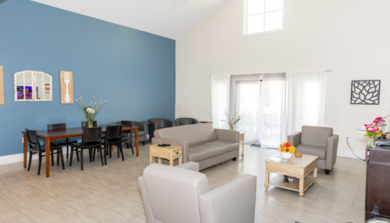 A living room photo of Westwood residence, Grey couches, black table and chairs