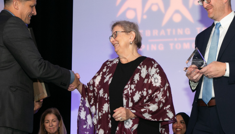 ETC Gina shaking hands while receiving award for Supervisor 