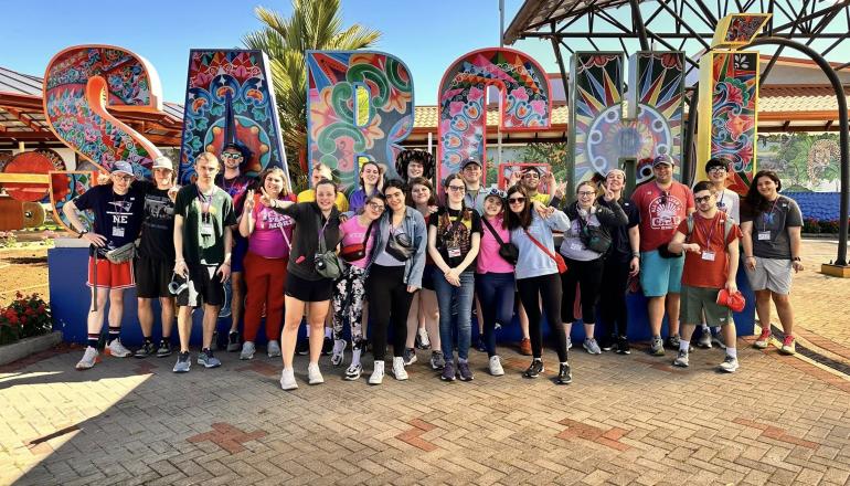 Group photo of RiverView Students in front of large sign 